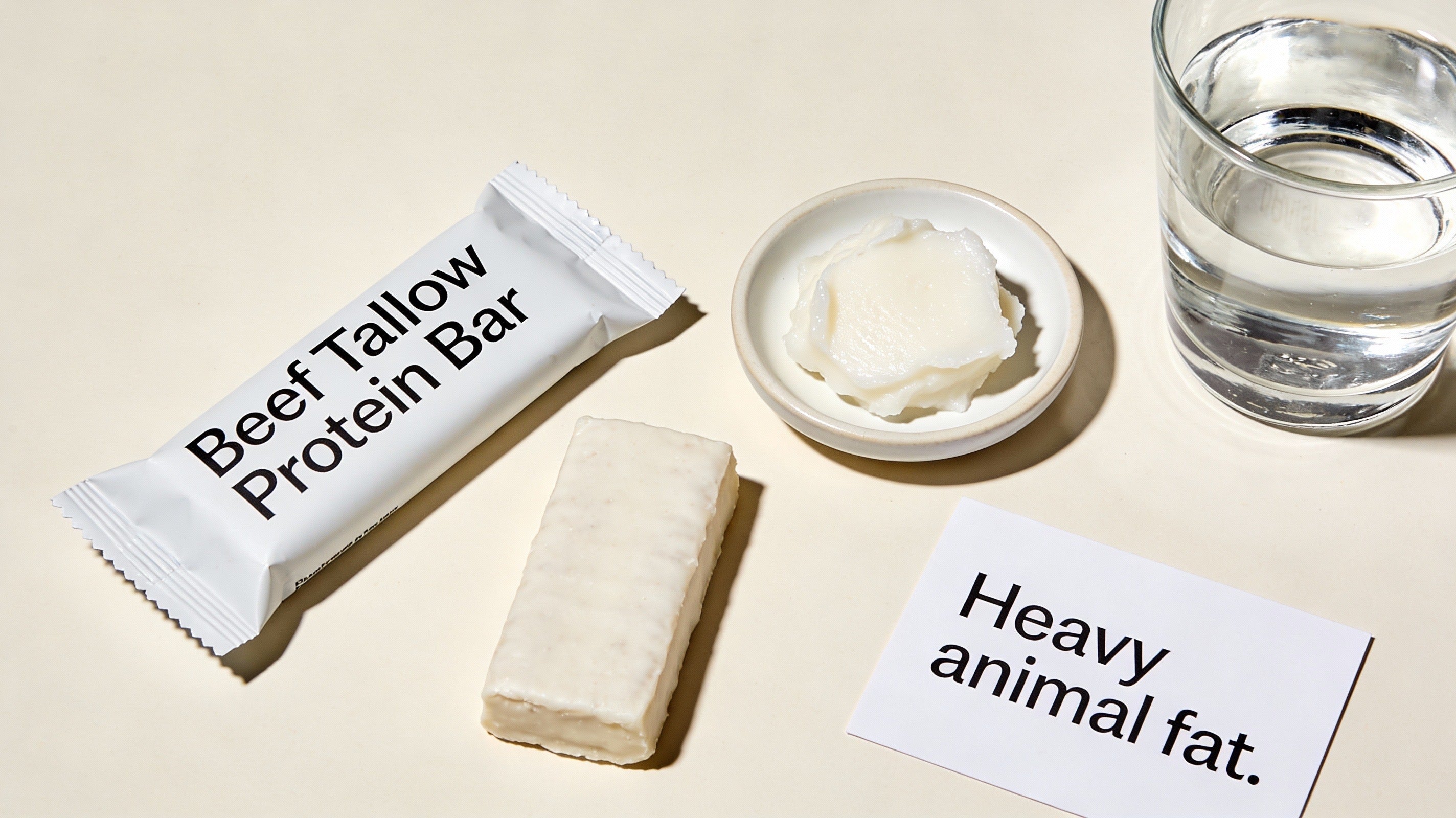 Beef tallow protein bar shown beside beef tallow, highlighting heavy animal fat