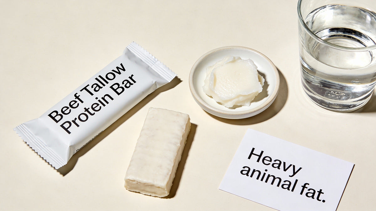 Beef tallow protein bar shown beside beef tallow, highlighting heavy animal fat