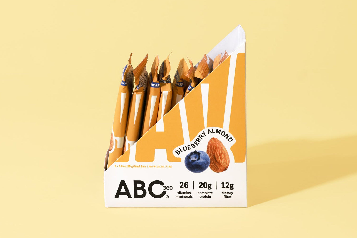 A box of ABC360BAR.COM Blueberry Almond protein bars is shown on a yellow background. The open box reveals several bars, and the packaging features images of an almond and a blueberry to highlight gut health.