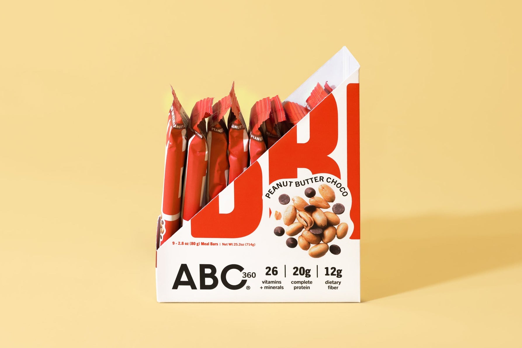 A display box of ABC360BAR.COM Peanut Butter Choco bars with added marine collagen protein is shown on a yellow background. Partially unwrapped bars stand upright, featuring nutrition info and images of peanuts and chocolate.