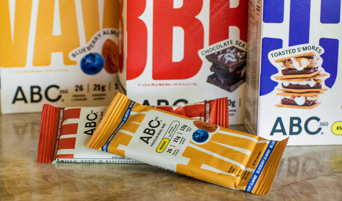 ABC 360® Blueberry Almond and Peanut Butter Choco Protein Meal Bars in front of Blueberry Almond, Chocolate Sea Salt, and Toasted S’mores boxes.
