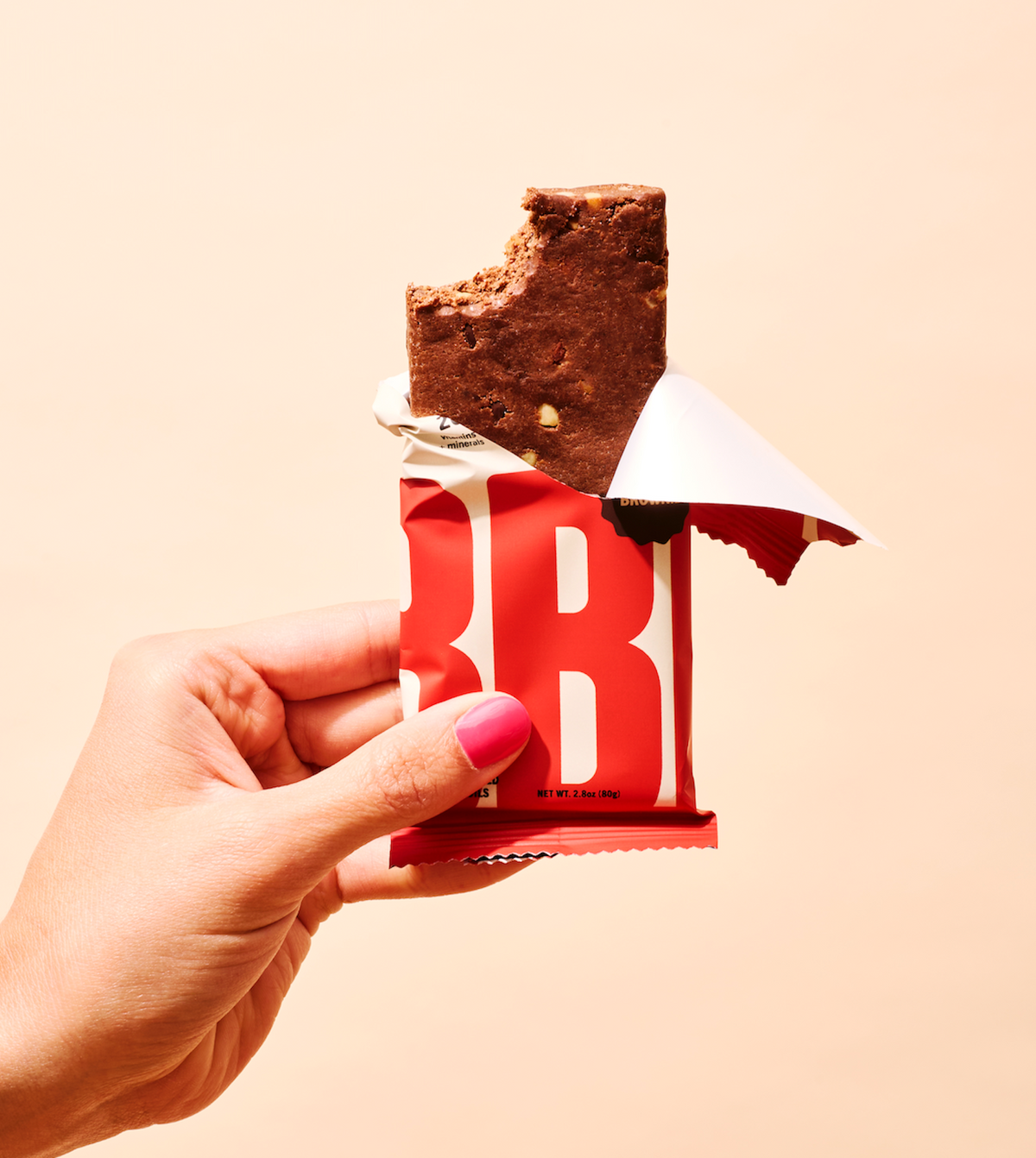A partially unwrapped Chocolate Sea Salt ABC 360 B protein bar with a bite taken out, infused with marine collagen, the best meal replacement bars.